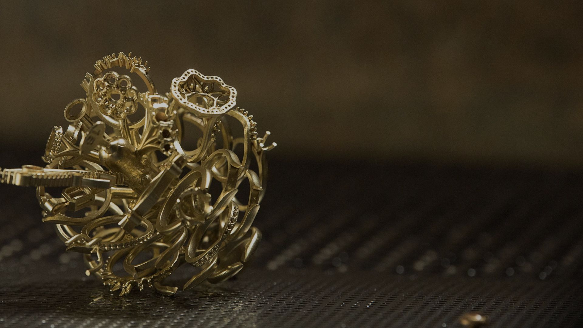 A chaotic bundle of metallic gears and cogs rests on a ribbed surface in dim light, conveying a sense of complexity and mechanical intricacy.