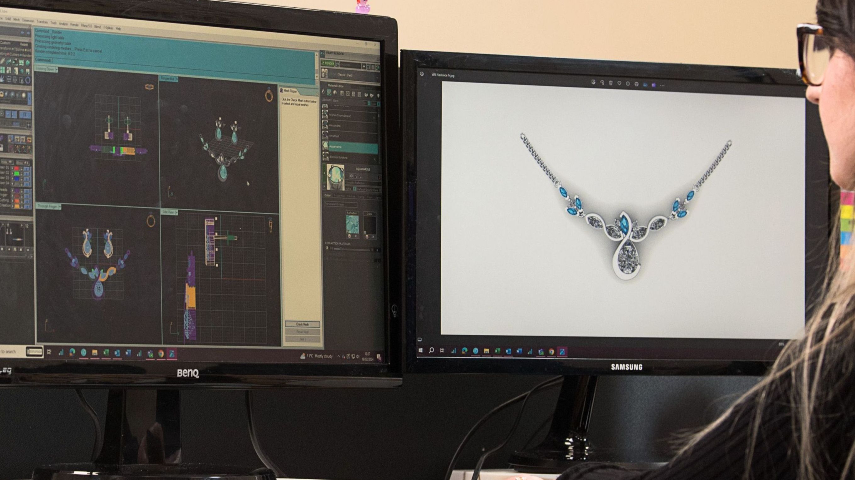 a woman in glasses reviews jewellery designs on dual monitors