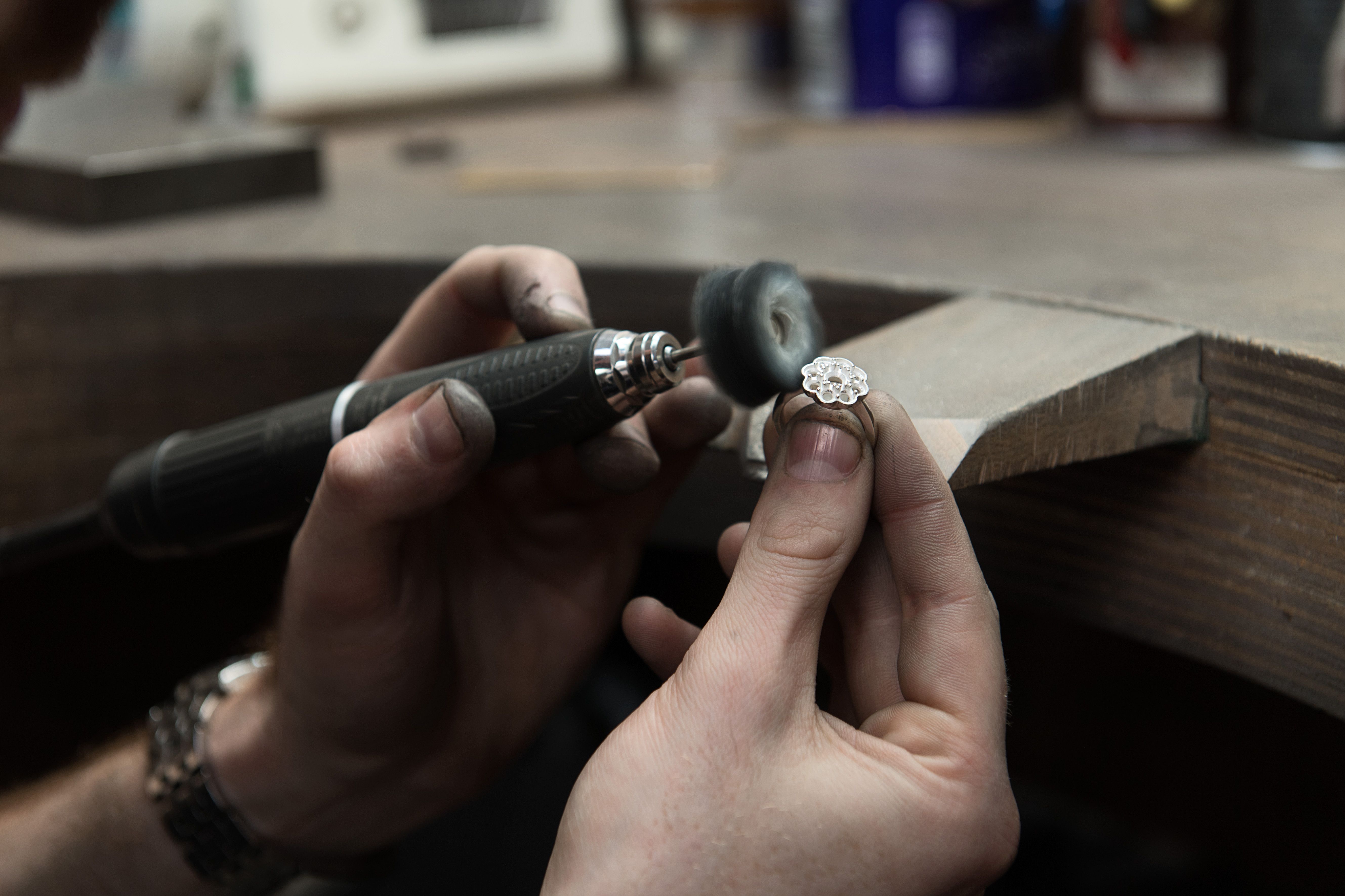 a ring being polished by hand in a workshop